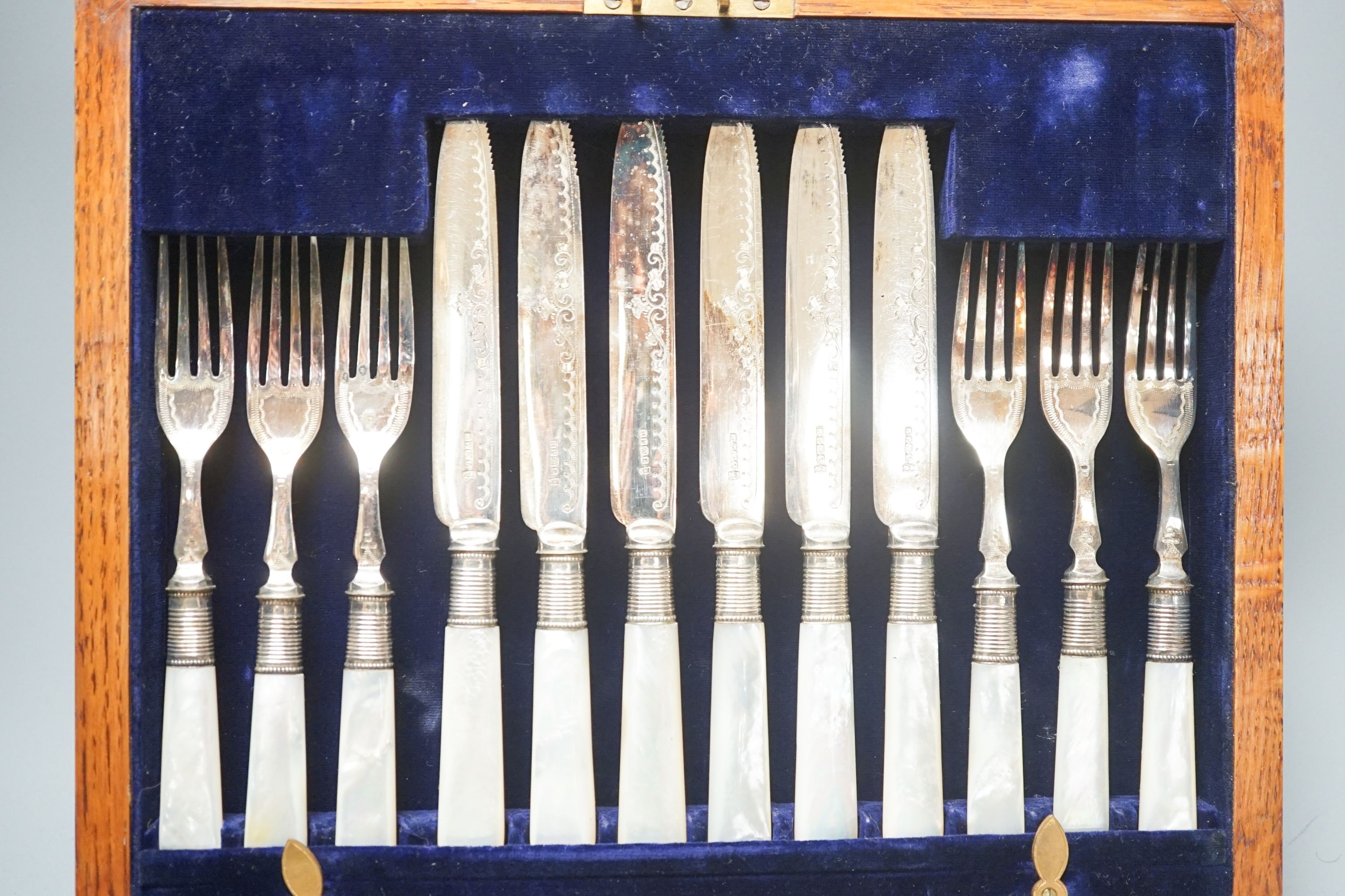 A cased set of silver teaspoons and tongs, a silver mounted cigarette case and plated part dessert service